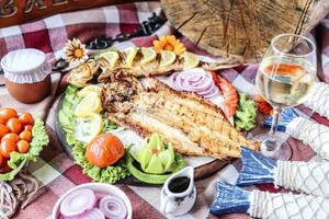 Fresh Fish and Colorful Vegetables on Wooden Table photo