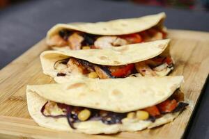 Wooden Cutting Board With Three Tortillas photo