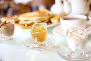 Cups and Saucers Filled With Liquid Resting on a Table photo