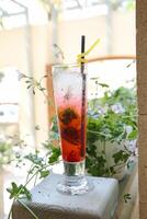 Tall Glass Filled With Drink on Cement Block photo