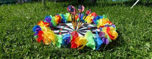 dartboard with a lgbt colored garland around it photo