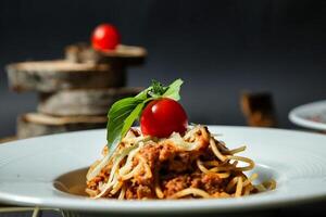 White Plate With Spaghetti and Cherry Garnish photo