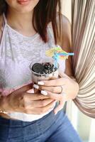 Woman Holding a Drink at a Social Gathering photo