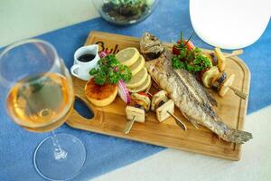 Delicious Plate of Food and Glass of Wine on Table photo