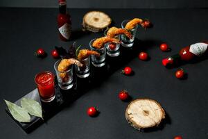 Black Table With Glasses Filled With Food photo