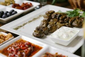 Close Up of Multiple Plates of Food on Table photo