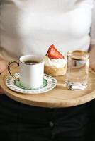 Person Holding Tray With Coffee Cup and Strawberry photo