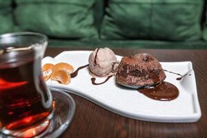 White Plate With Dessert Next to Cup of Tea photo