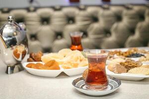 Table With Plates of Food and Cups of Tea photo
