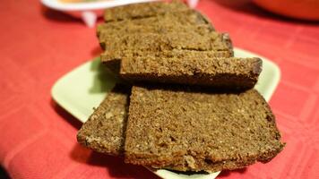 Sliced vort bread served on a green saucer photo