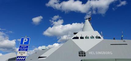 Stockholm, Sweden, June 4, 2022 a glimpse of a battleship docked at the pier. photo