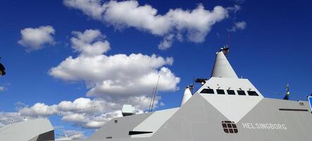 Stockholm, Sweden, June 4, 2022 a glimpse of a battleship docked at the pier. photo