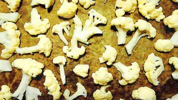 A baking pan filled with cauliflower flowers to roast and dress with salad. photo