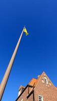 Ostersund, Sweden, March 13, 2022 The impressive historic town hall building displaying the Ukrainian flag. photo