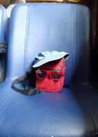 a red bag and a cork bag with glasses photo