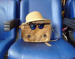 a red bag and a cork bag with glasses photo