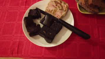 video of a buffet with sliced bread, pork blood dessert, mixed cold cuts and butter photo