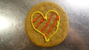 Ginger cookie decorated with a colorful heart photo