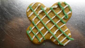 Ginger cookie in the shape of a colorful four leaf clover photo