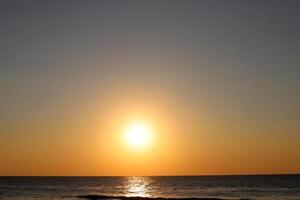 Lighting and color of the sky above the horizon at sunset. photo