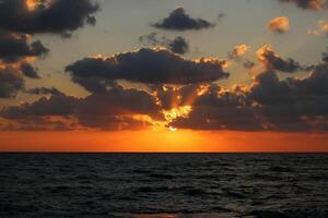 Lighting and color of the sky above the horizon at sunset. photo