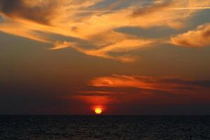 Lighting and color of the sky above the horizon at sunset. photo