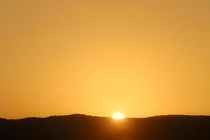 Lighting and color of the sky above the horizon at sunset. photo