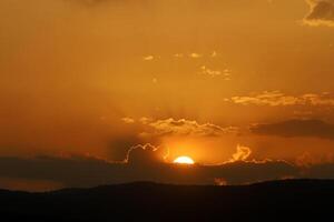 Encendiendo y color de el cielo encima el horizonte a puesta de sol. foto