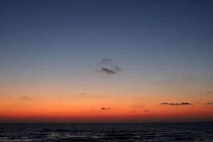 Lighting and color of the sky above the horizon at sunset. photo