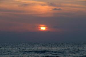 Lighting and color of the sky above the horizon at sunset. photo