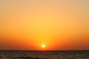 Lighting and color of the sky above the horizon at sunset. photo