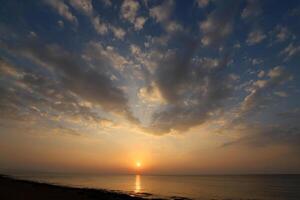 Lighting and color of the sky above the horizon at sunset. photo