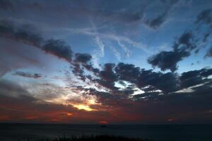 Lighting and color of the sky above the horizon at sunset. photo