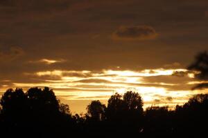 Lighting and color of the sky above the horizon at sunset. photo