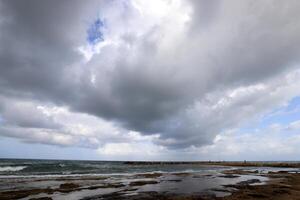 Rain clouds in the sky over the Mediterranean Sea. photo