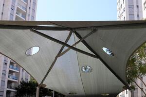 Canopy for protection from the hot sun in a city park. photo