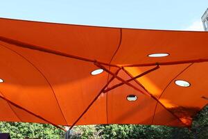 Canopy for protection from the hot sun in a city park. photo