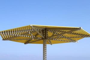 Canopy for protection from the hot sun in a city park. photo