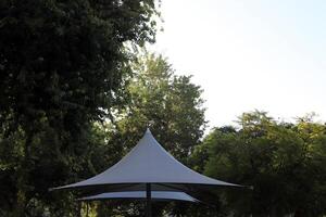 Canopy for protection from the hot sun in a city park. photo