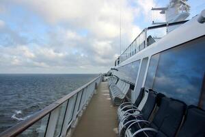 On the upper deck of a large ocean liner. photo