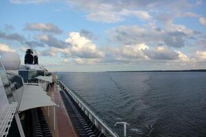 On the upper deck of a large ocean liner. photo