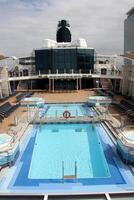 On the upper deck of a large ocean liner. photo