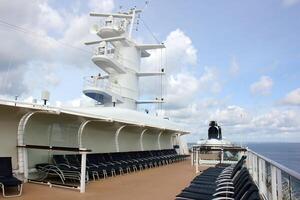 On the upper deck of a large ocean liner. photo