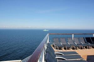 On the upper deck of a large ocean liner. photo