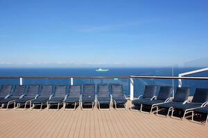 On the upper deck of a large ocean liner. photo