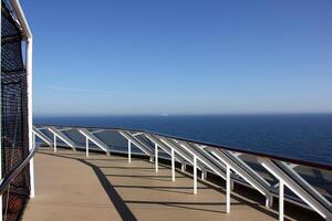 On the upper deck of a large ocean liner. photo