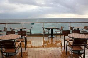 On the upper deck of a large ocean liner. photo