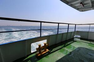 On the upper deck of a large ocean liner. photo