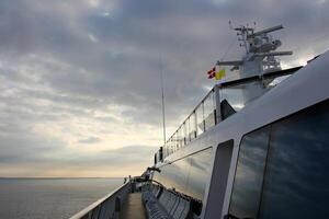 On the upper deck of a large ocean liner. photo