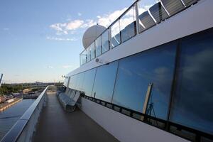 On the upper deck of a large ocean liner. photo